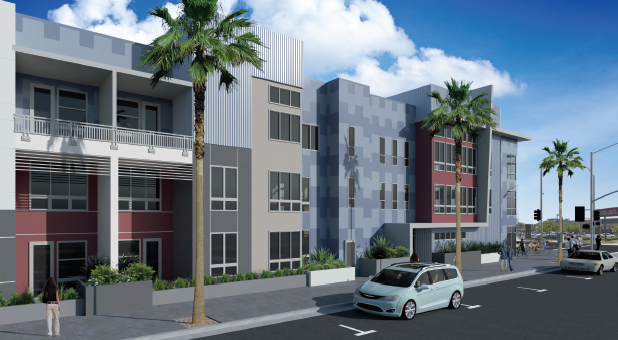 A car is driving down a street in front of a building with palm trees.
