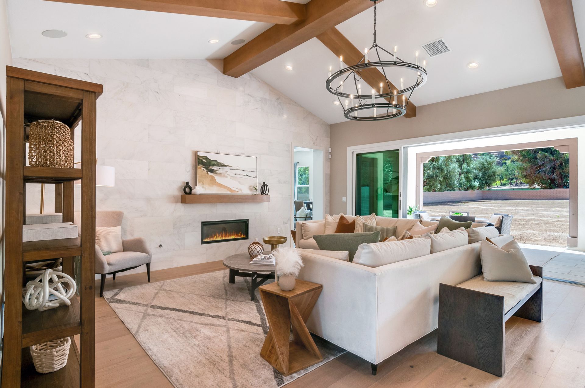 A living room with a couch , chairs , and a fireplace.
