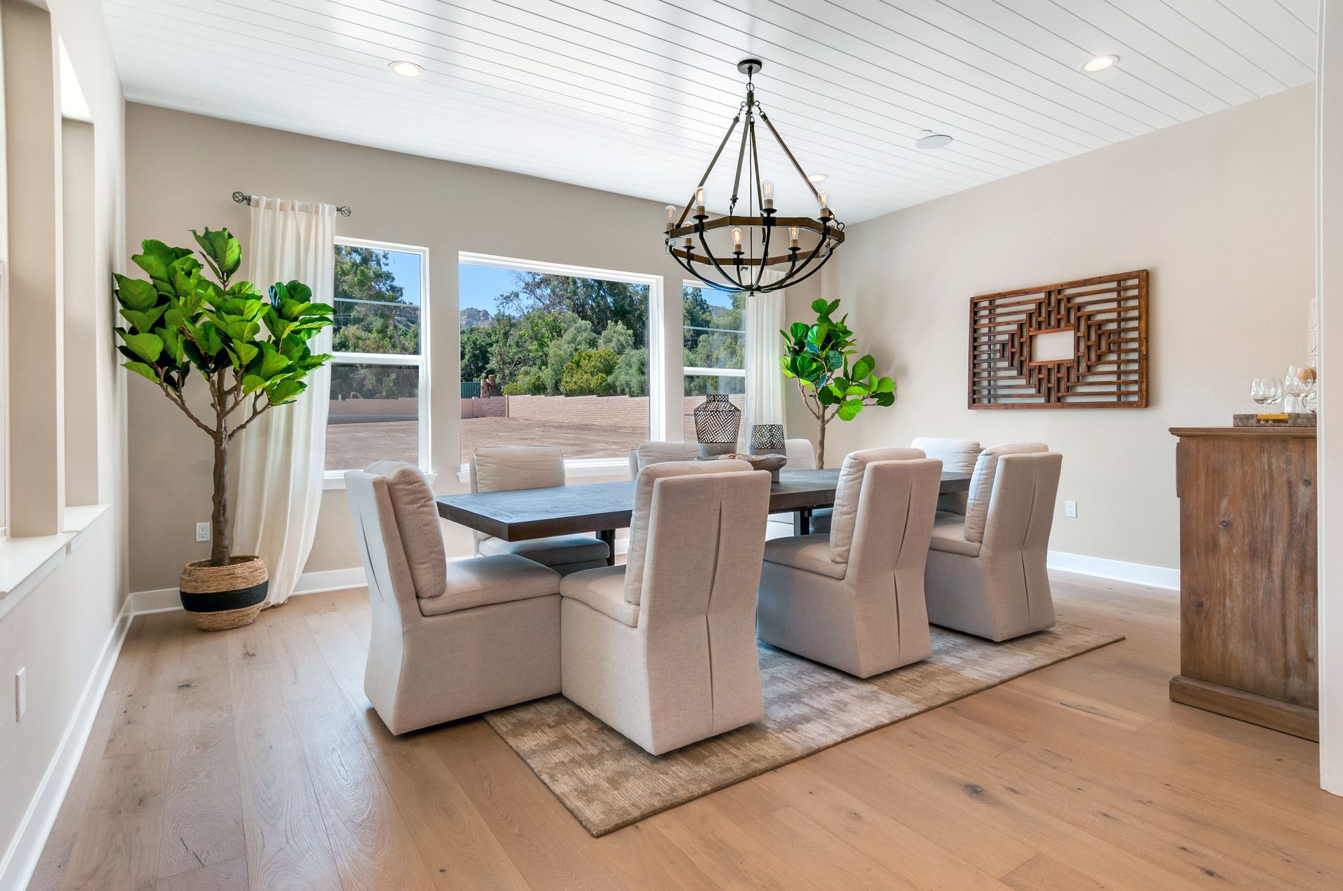 A dining room with a table and chairs and a chandelier.