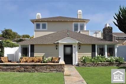 A large house with a stone walkway leading to it