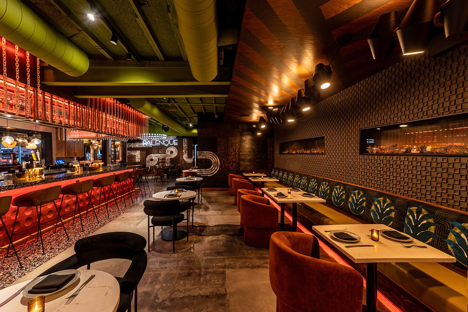 A restaurant with tables and chairs and a bar.