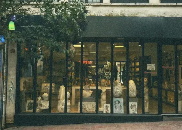 Storefront with large glass windows displaying products inside under a dark awning.