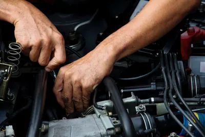 A Man is Working on the Engine of a Car — Quick Fix Automotive in Ballina, NSW