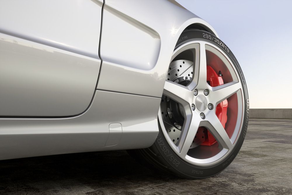 Silver Car's Wheel With a Red Brake Caliper — Autopro Taree in Taree, NSW