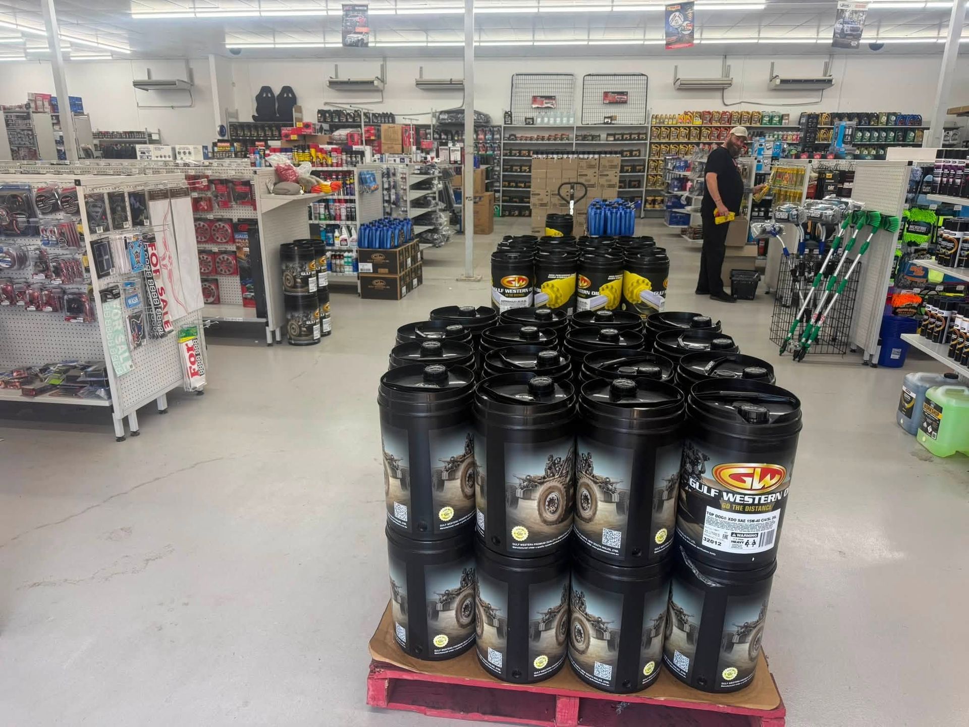 Retail Store Aisle With Stacked Containers and Shelves of Merchandise — Autopro Taree in Taree, NSW