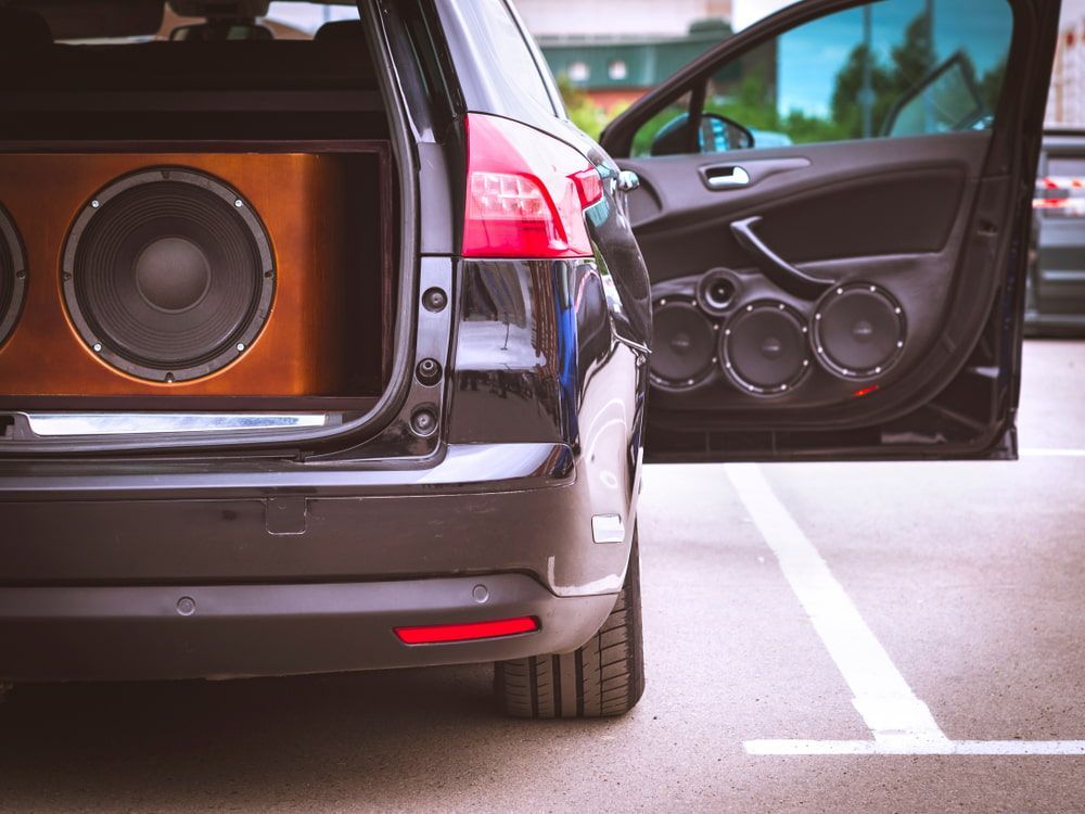 Black Car With Open Door Revealing Large Speakers — Autopro Taree in Taree, NSW