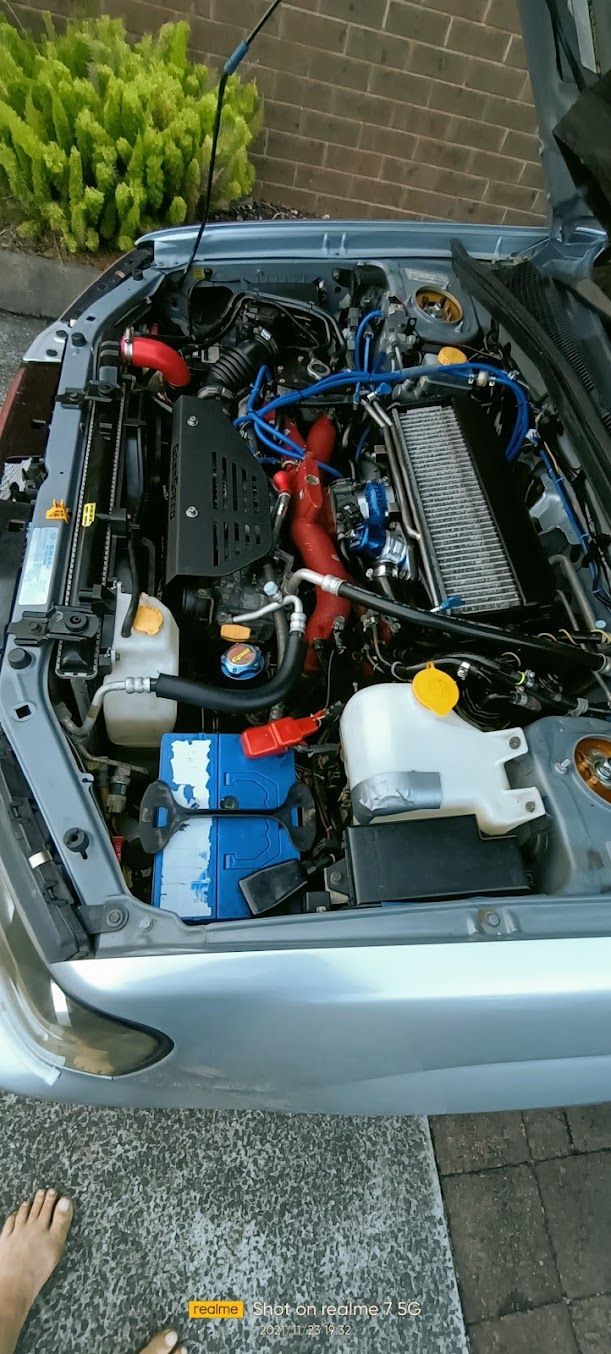 Open Car Engine Bay With Visible Hoses, Wires, and Components — Autopro Taree in Taree, NSW