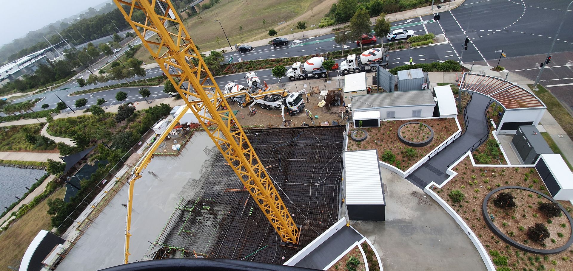 An aerial view of a construction site with a crane in the foreground