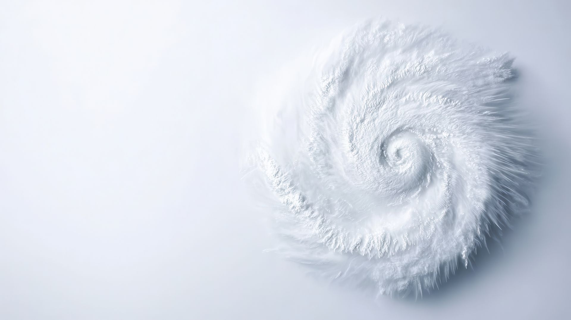Spiral of white powder, resembling a hurricane, on a white surface.