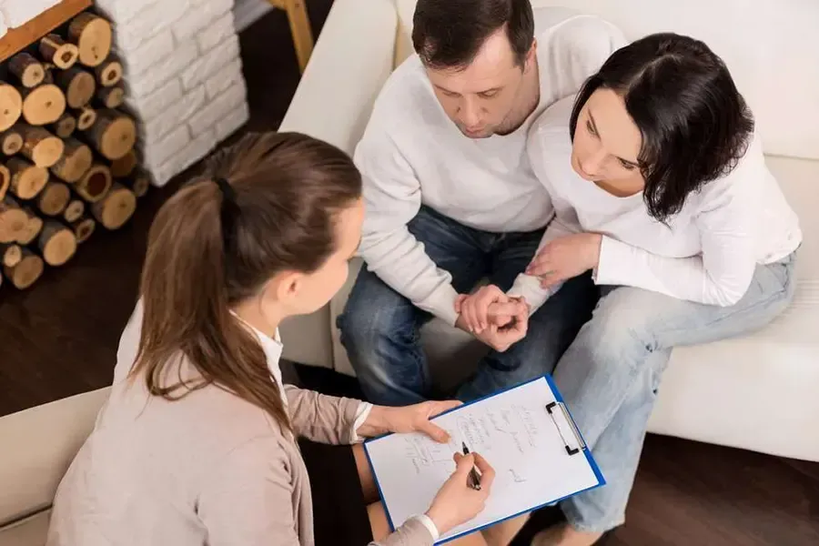 A couple having a counseling session with a therapist