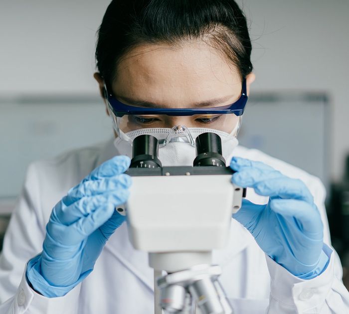 Doctor Using Microscope — Bakersfield, CA — American Digestive Liver & Nutritional Disease Center