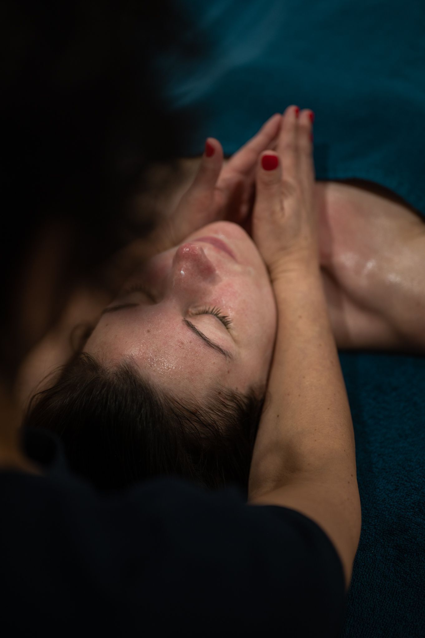 Une femme se fait masser le visage dans un spa.