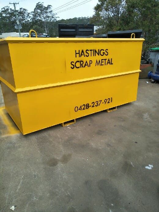 A Red Mobile Skip Bin is Parked in a Garage — Hastings Scrap Metal Recyclers in Wauchope, NSW