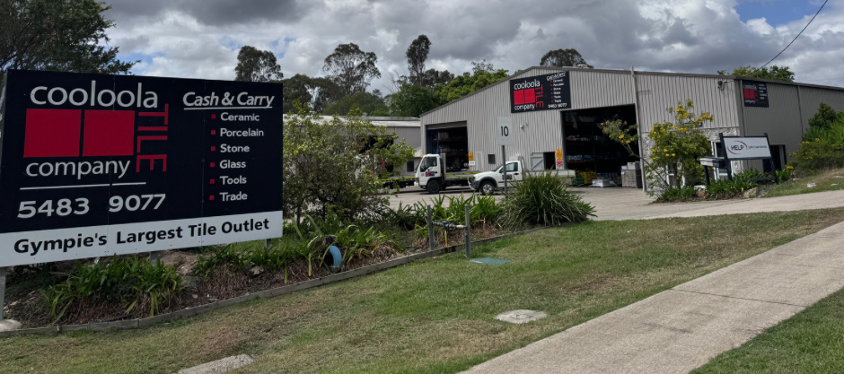 White Truck Parked Nearby. Green Grass and Trees Around the Building — Cooloola Tile Company in Gympie, QLD