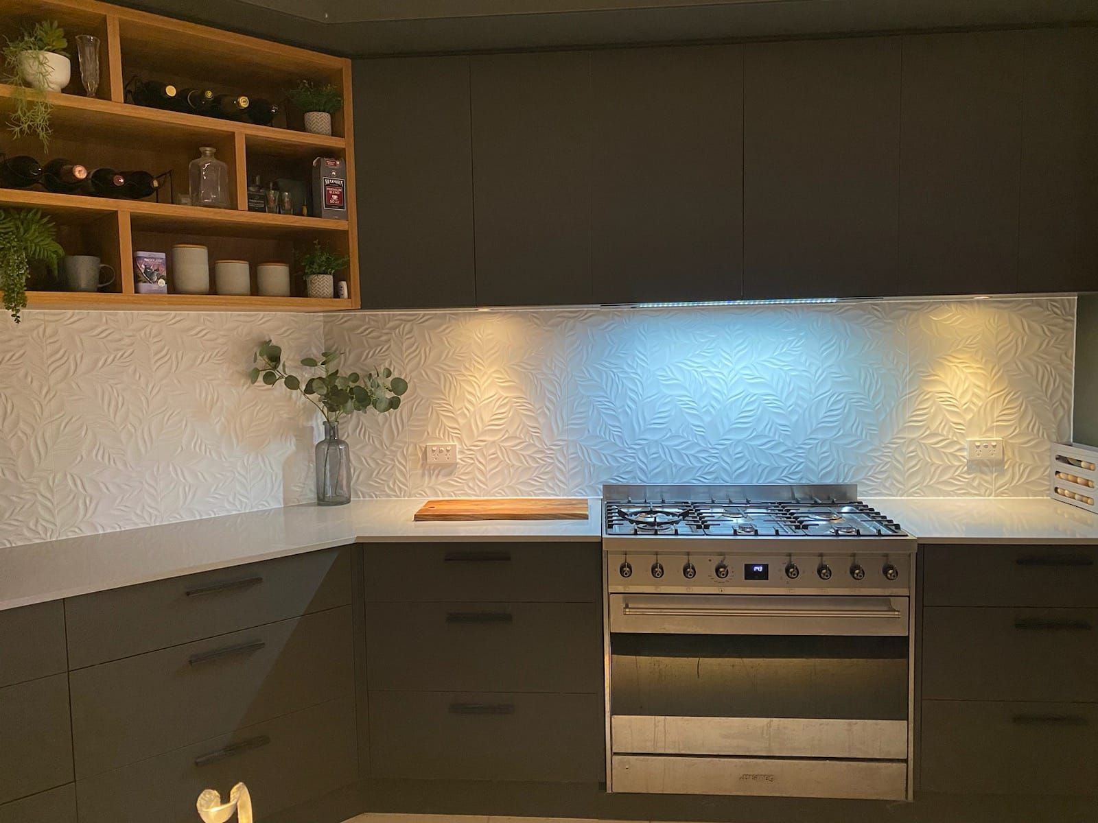 Modern Kitchen With Grey Cabinets, White Textured Backsplash, and Open Wooden Shelving — Cooloola Tile Company in Gympie, QLD