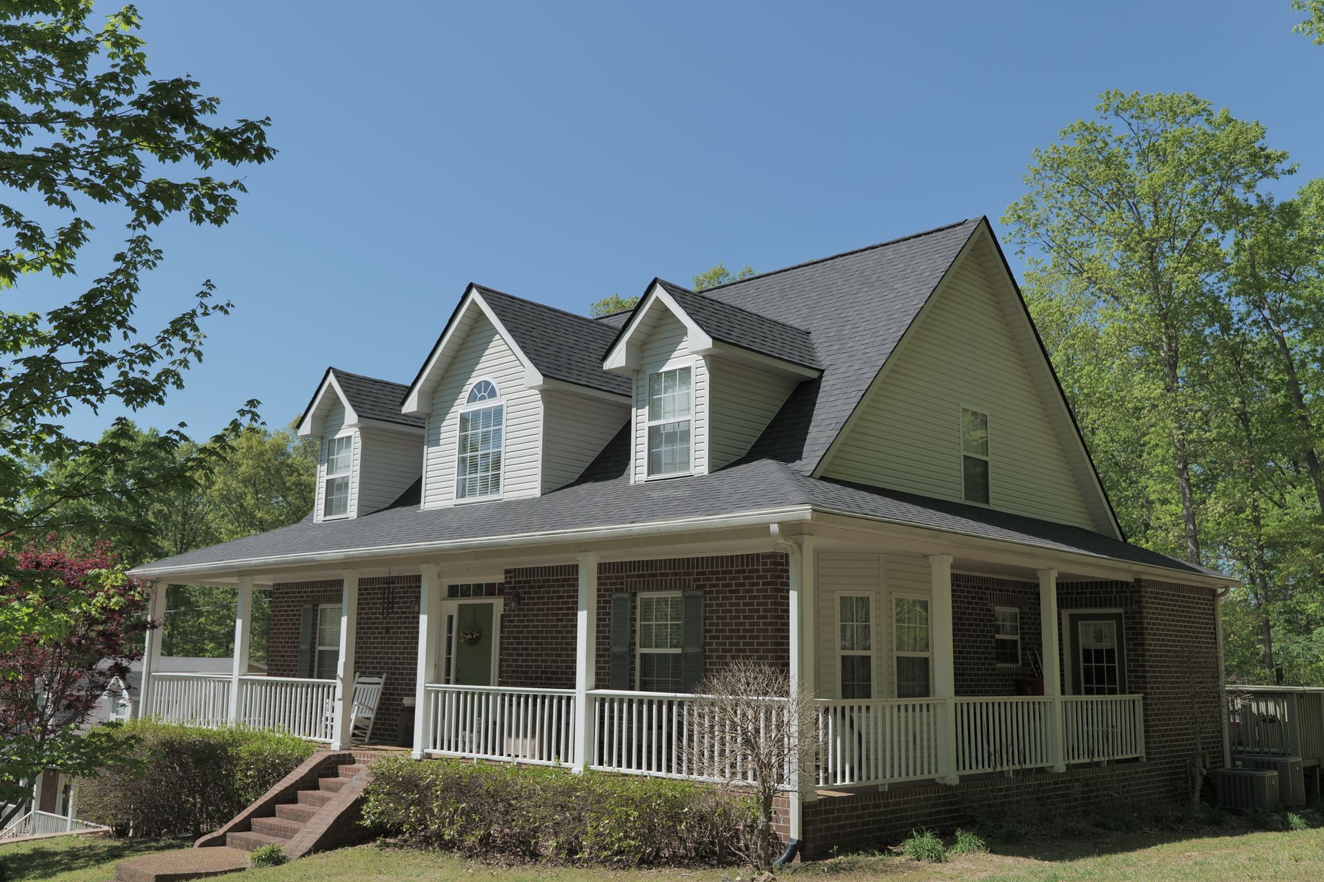 A house with a large porch and stairs leading up to it