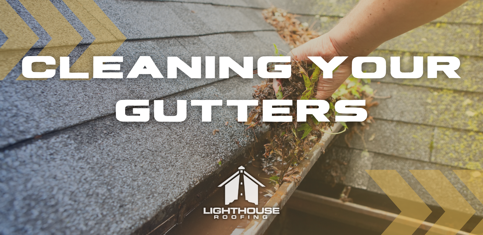 A person is cleaning a gutter on a roof.