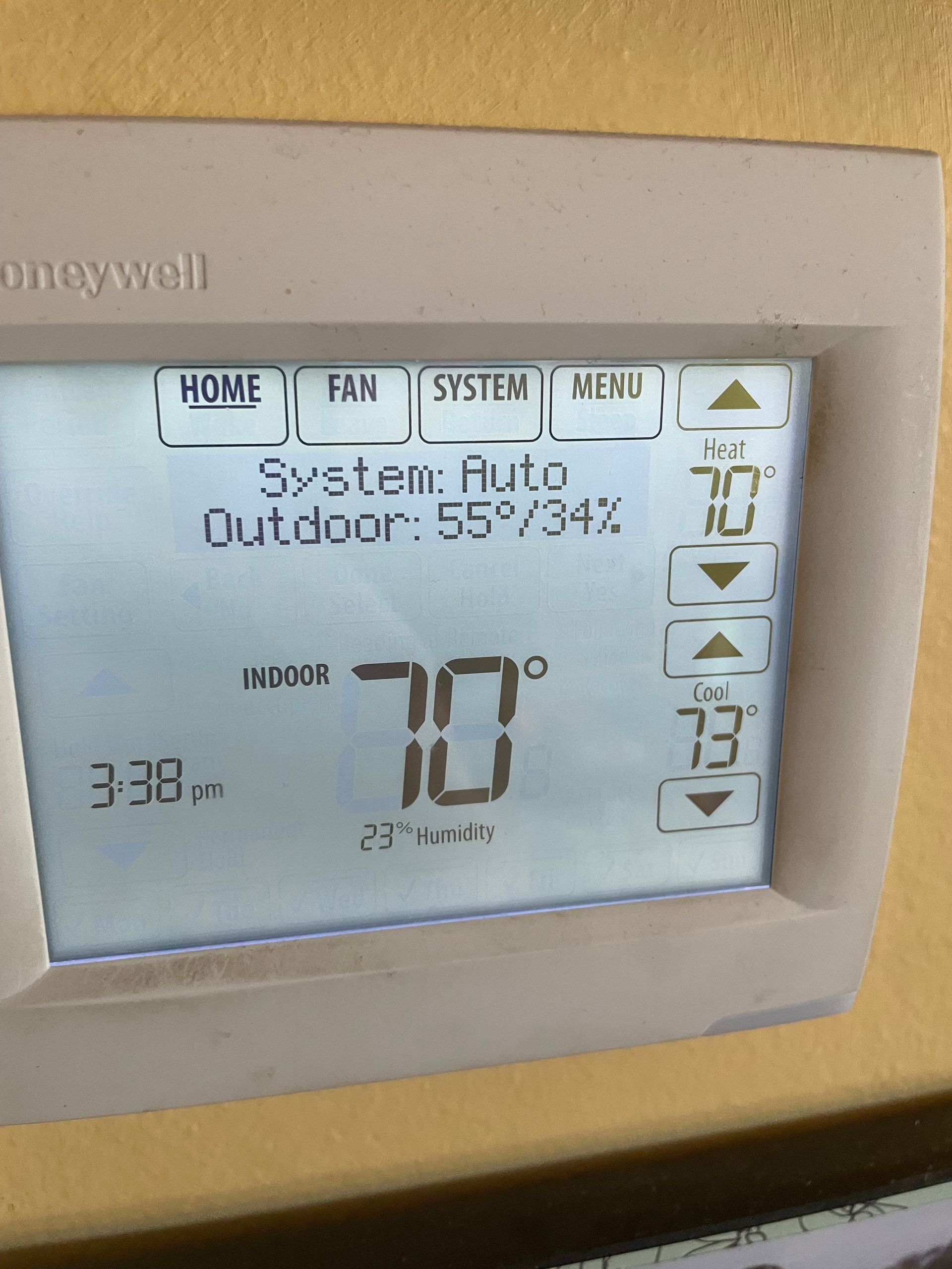 Honeywell thermostat display showing the system set to 