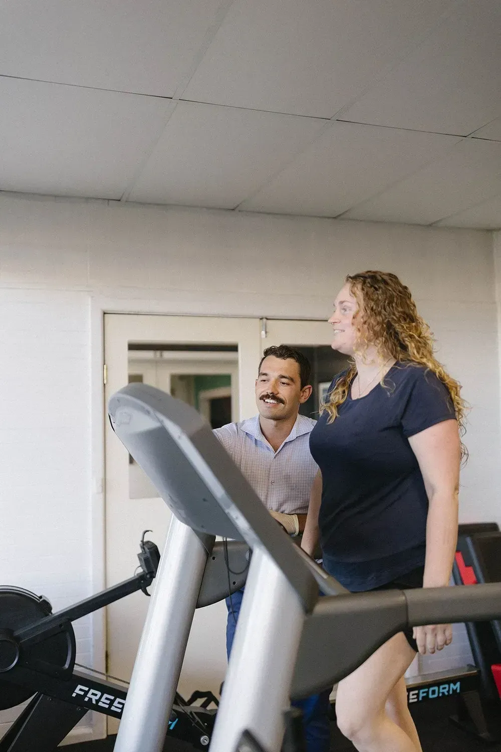 A Woman on a Treadmill With a Man Next to Her — Lord Street Podiatry in Port Macquarie, NSW