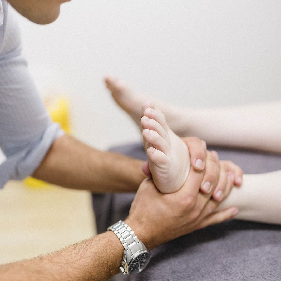 Therapist Holding a Patient’s Foot During a Massage or Therapy Session — Lord Street Podiatry in Port Macquarie, NSW