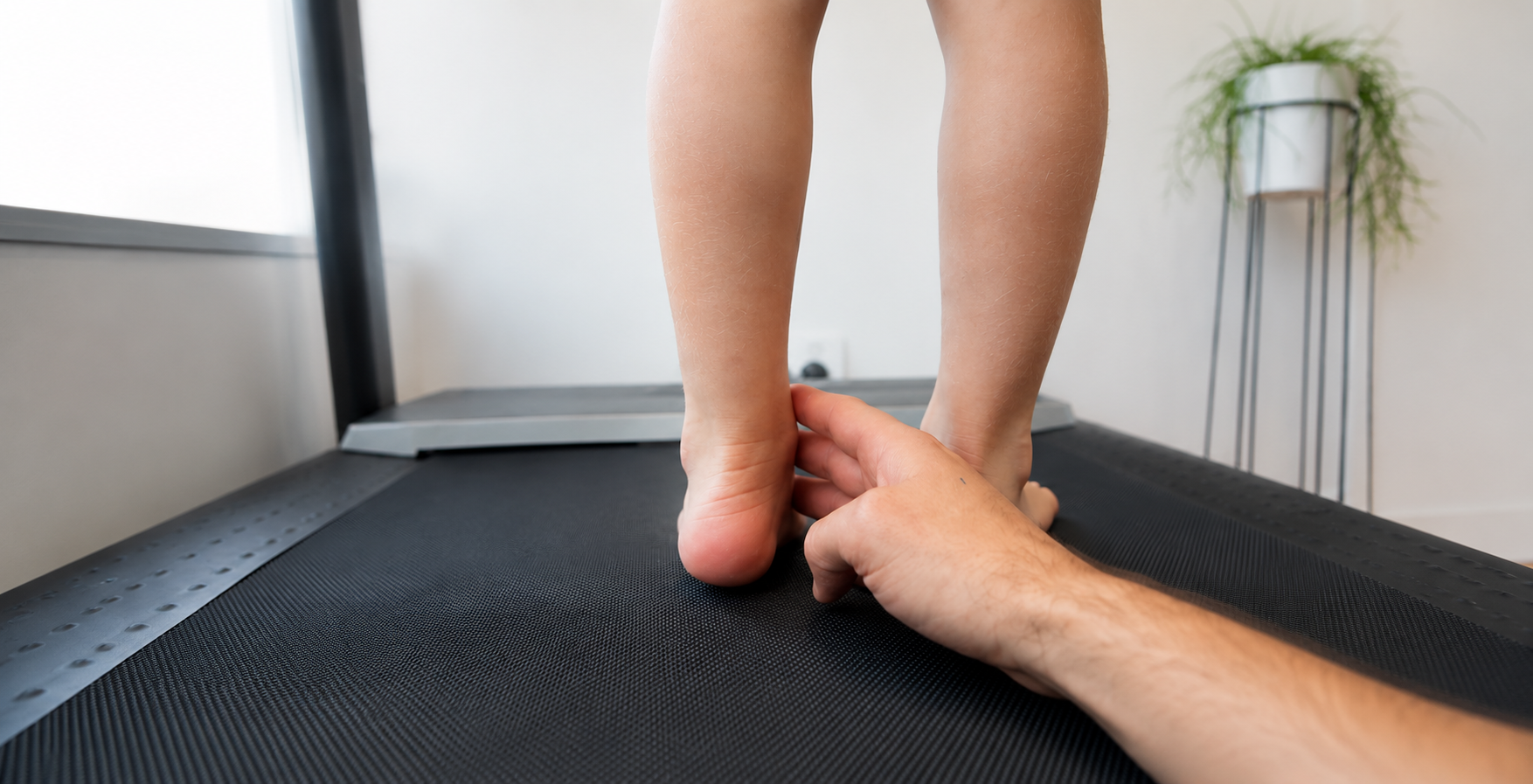 A Person Standing on a Black Mat While Another Hand Steadies Their Ankle — Lord Street Podiatry in Port Macquarie, NSW