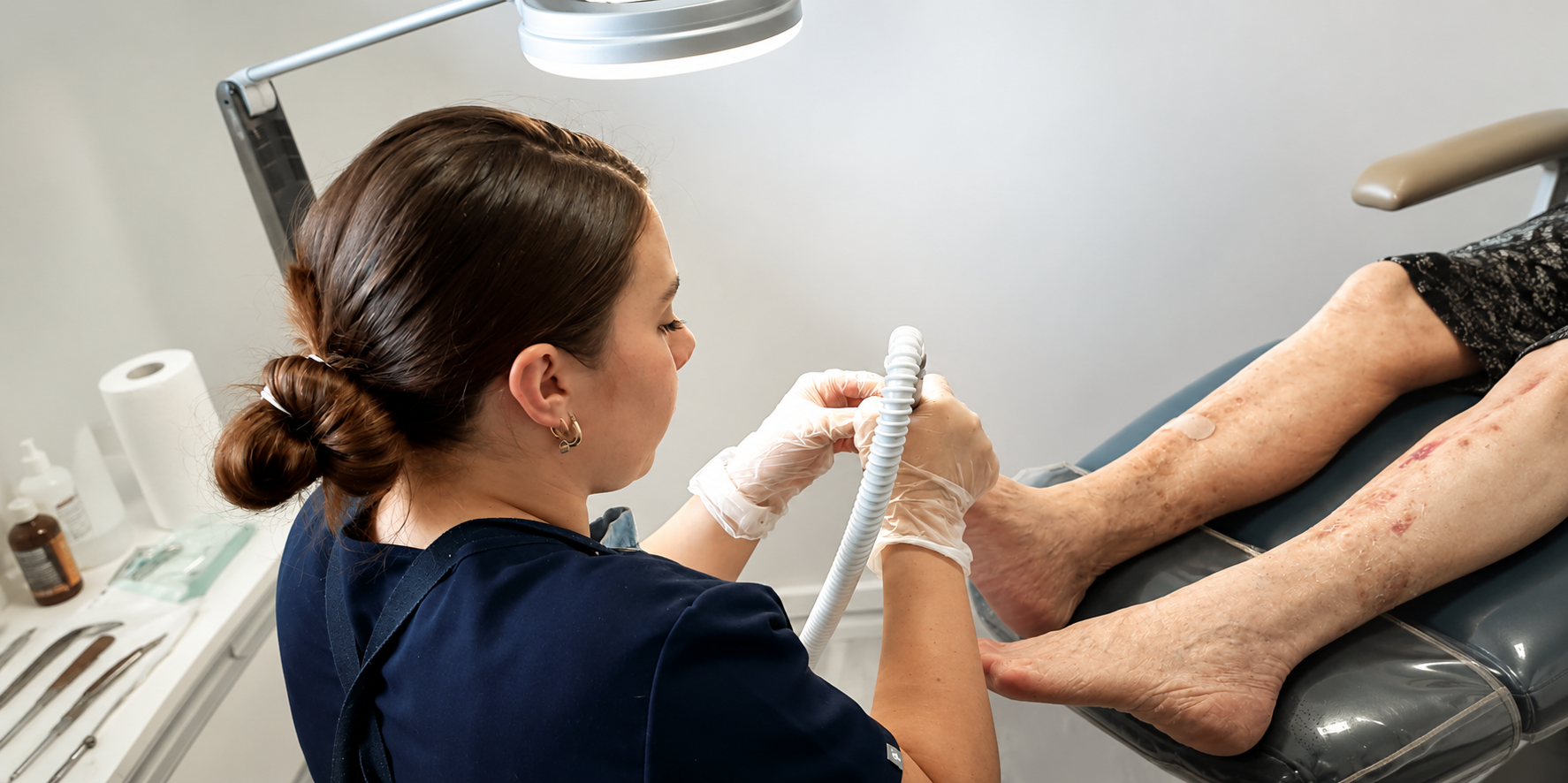 Podiatrist Treating a Patient's Feet in a Clinic, Using a Handheld Instrument — Lord Street Podiatry in Port Macquarie, NSW