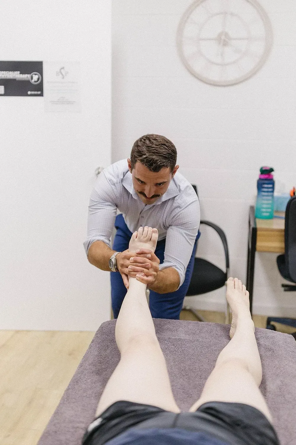 Massage Therapist Stretching a Client’s Foot — Lord Street Podiatry in Port Macquarie, NSW