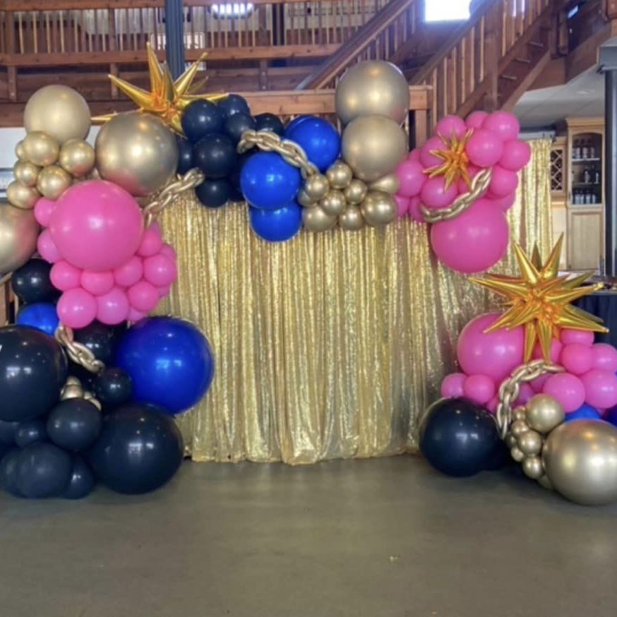 pipe and drape with a styled balloon garland for an 80s event 