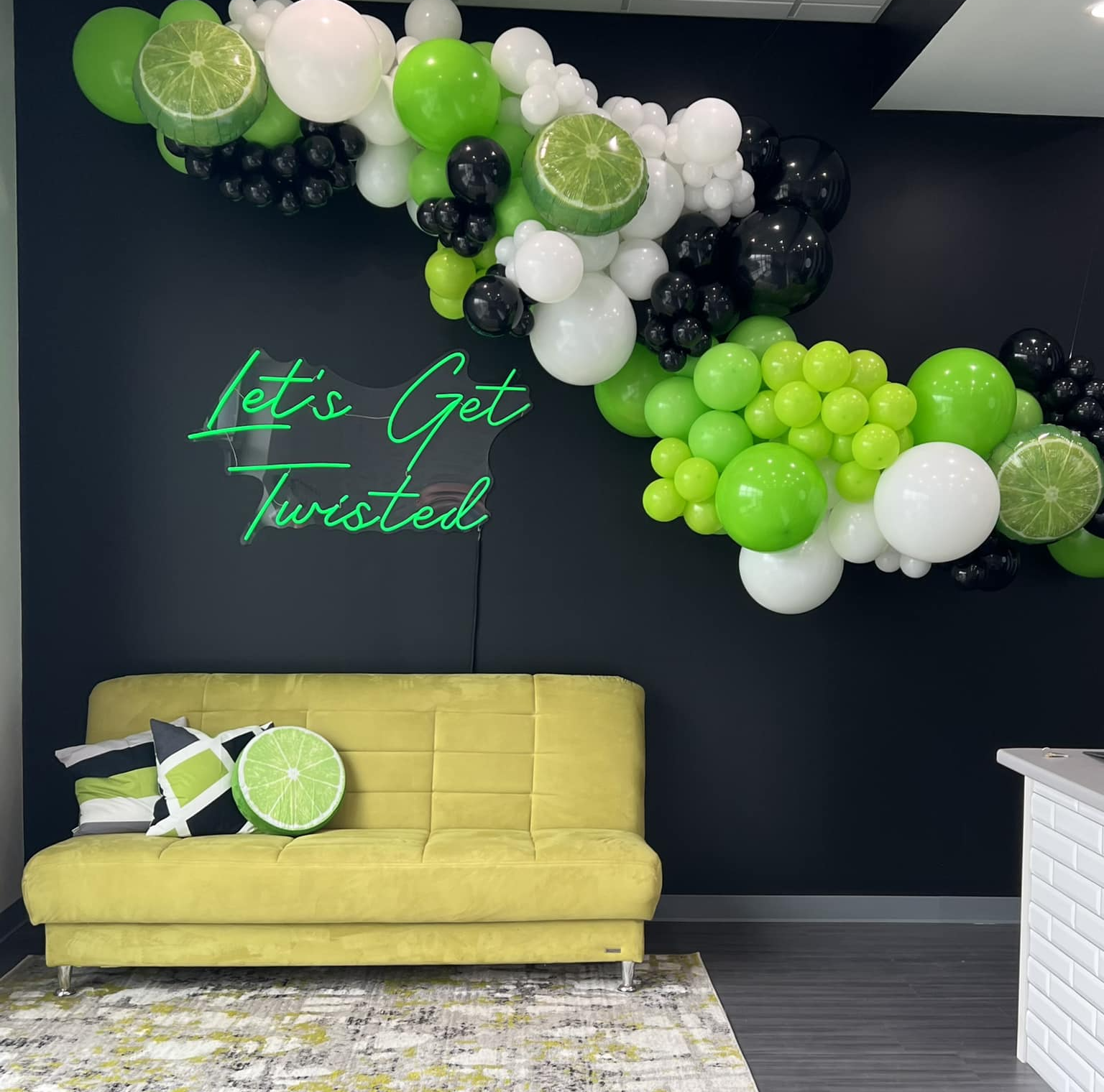 Simple balloon garland in custom brand colors with foil accents, hung on the wall for an affordable and effective event decoration, perfect for corporate branding, parties, and celebrations.