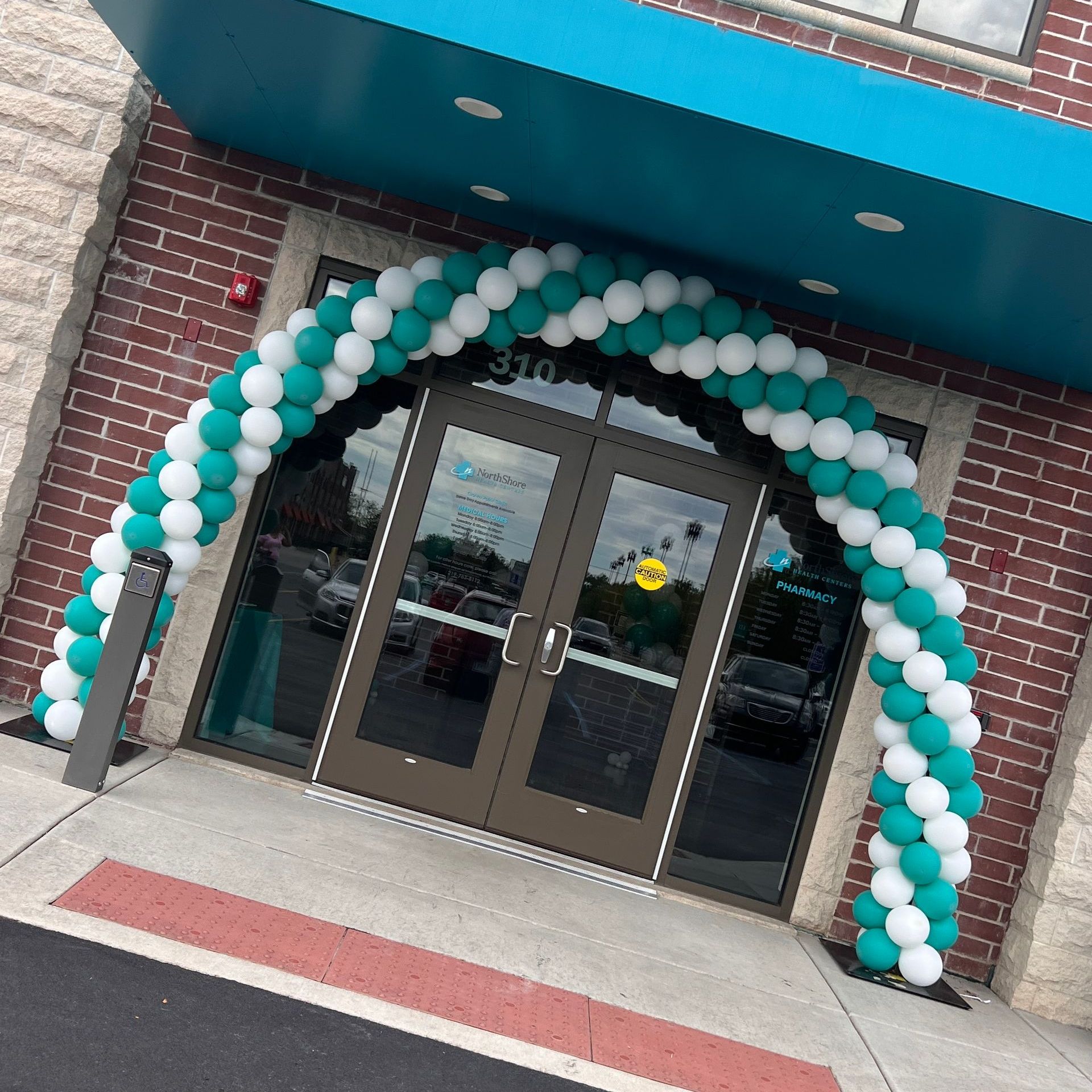 Northshore Health Center grand reopening in Crown Point, Indiana  featuring a spiral outdoor arch in company colors. A classic and simple design that perfectly complements the celebratory atmosphere of the event.