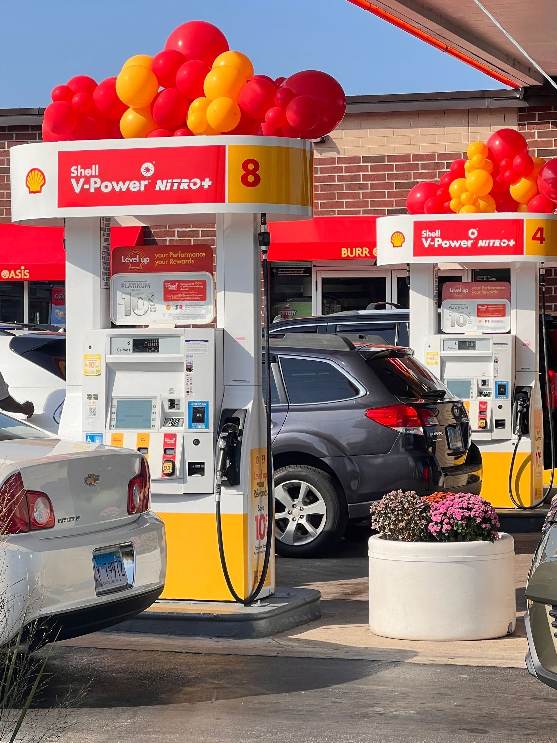 Organic red and yellow balloon garland with customized balloons, designed for  Shell corporation decor in Portage, IN.