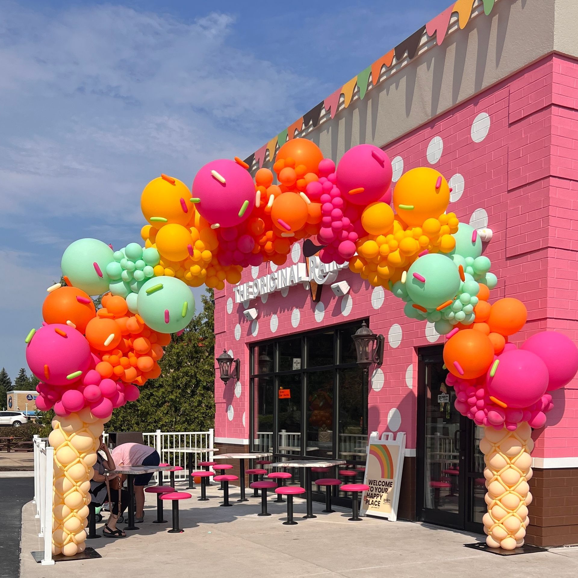 Grand Deluxe Ice Cream Balloon Arch for Rainbow Cone in Dyer, Indiana, featuring balloon scoops and colorful balloon sprinkles. An impossible-to-miss grand opening entrance that perfectly welcomes this beloved corporation to town with vibrant and playful decor.