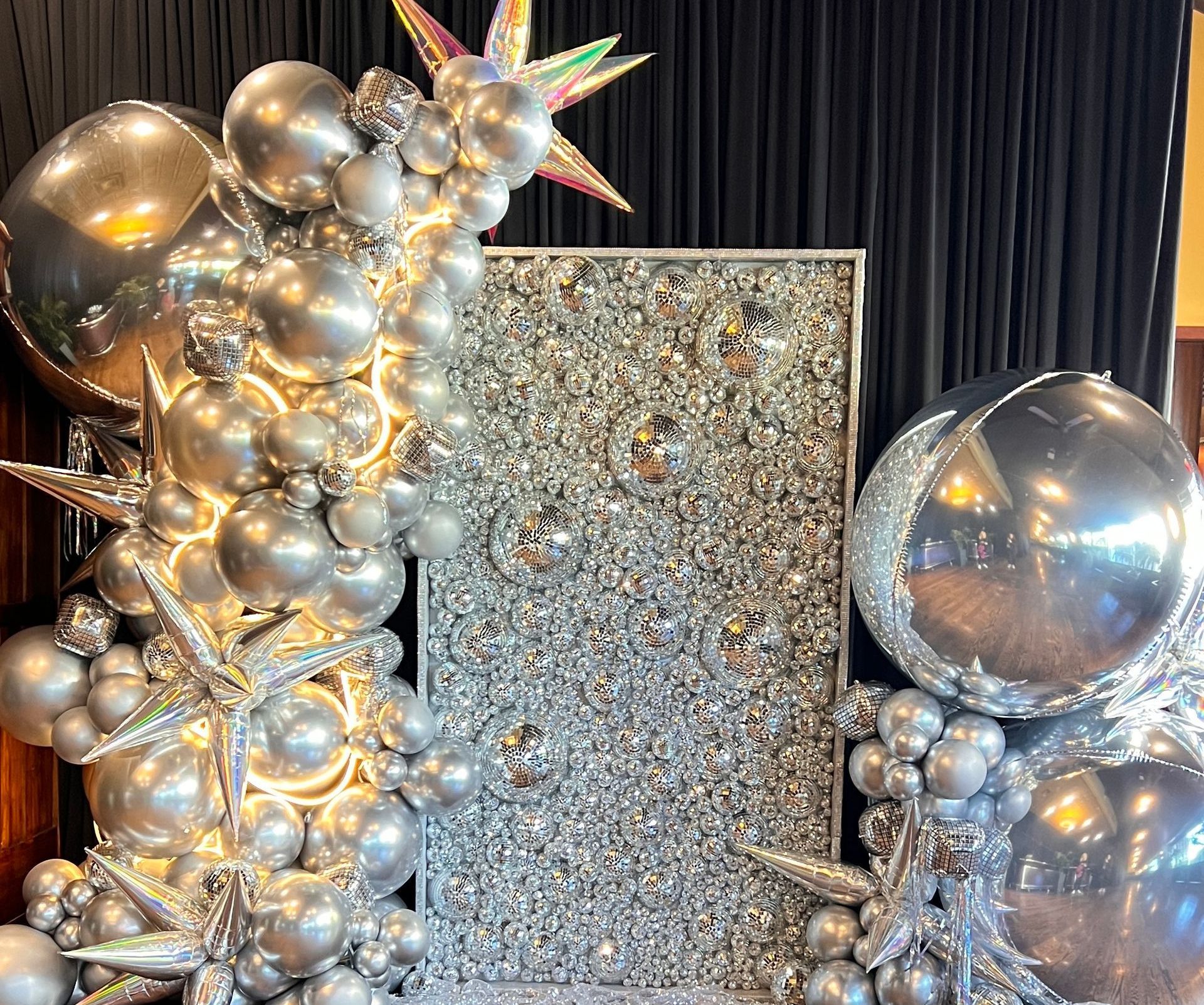 NWI's premier disco wall for a gala  and monochromatic silver balloon garlands for a gala.  High end luxury gorgeous balloon decorations 