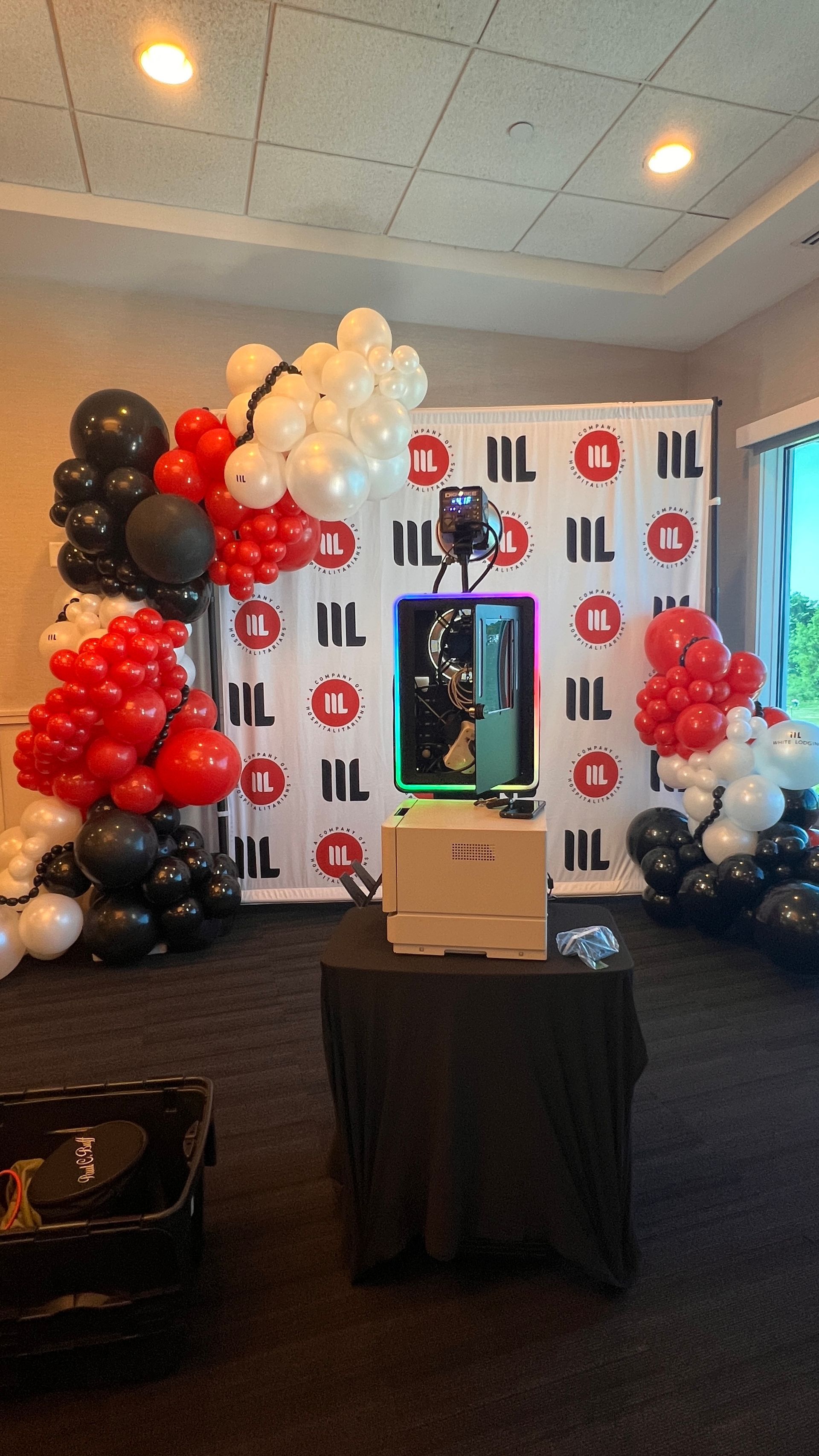 Corporate backdrop with organic grand balloon garland to accompy a photo booth. 