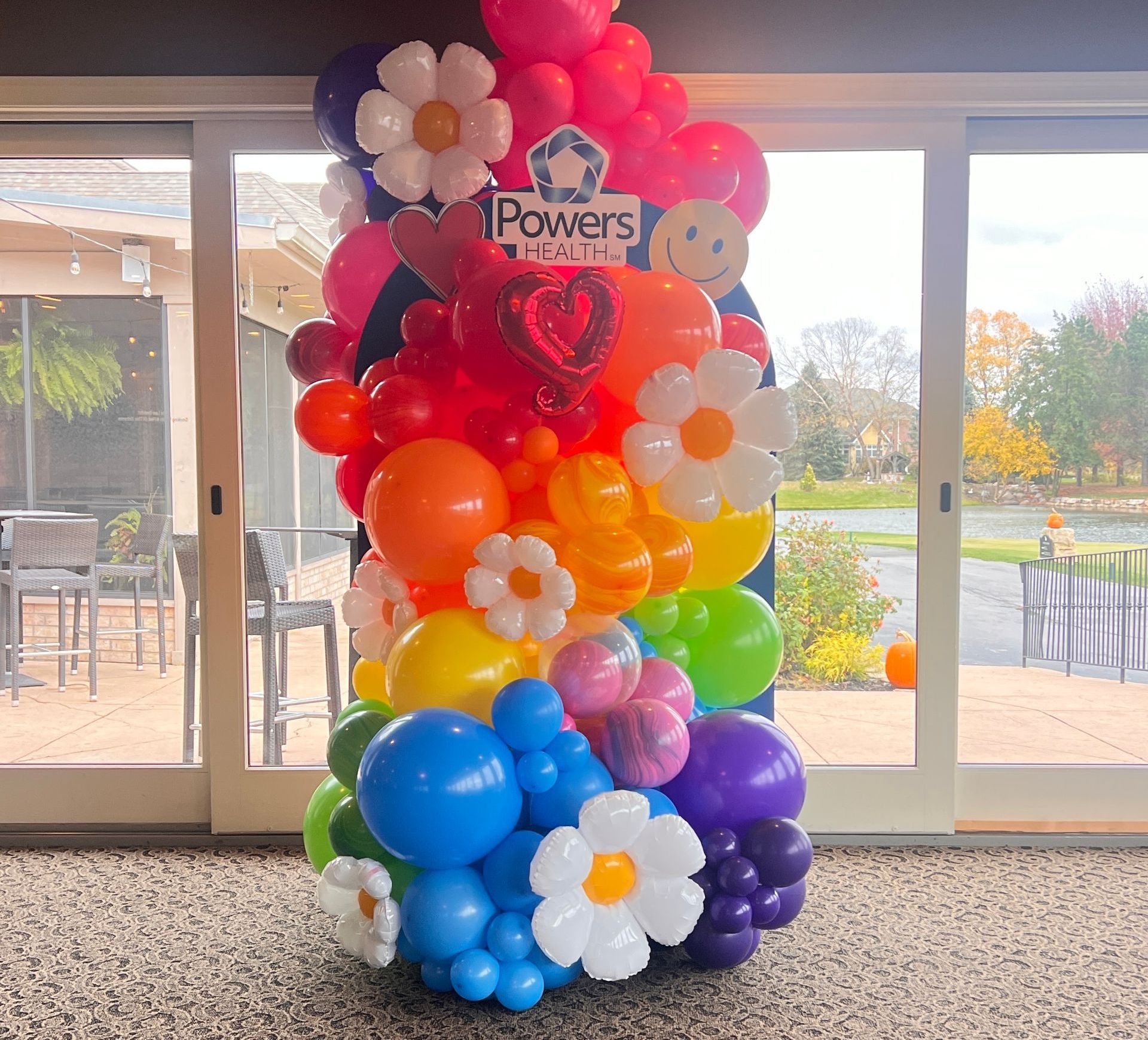 Love, health, and Powers 60s styled tie dye balloon garland for a team building event 
