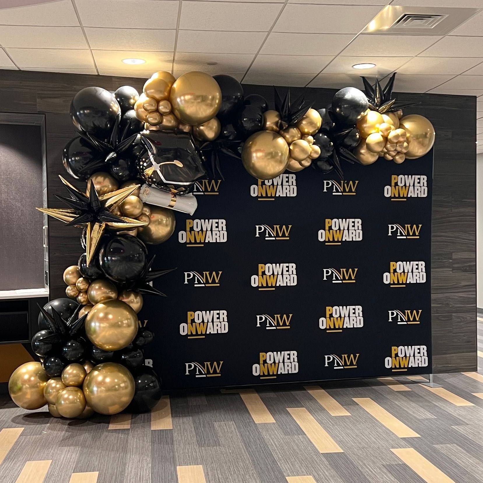 Deluxe organic balloon garland paired with a step-and-repeat backdrop, designed as an entry piece, photo op, and focal point. Fully customized and branded to elevate your event's style and impact.