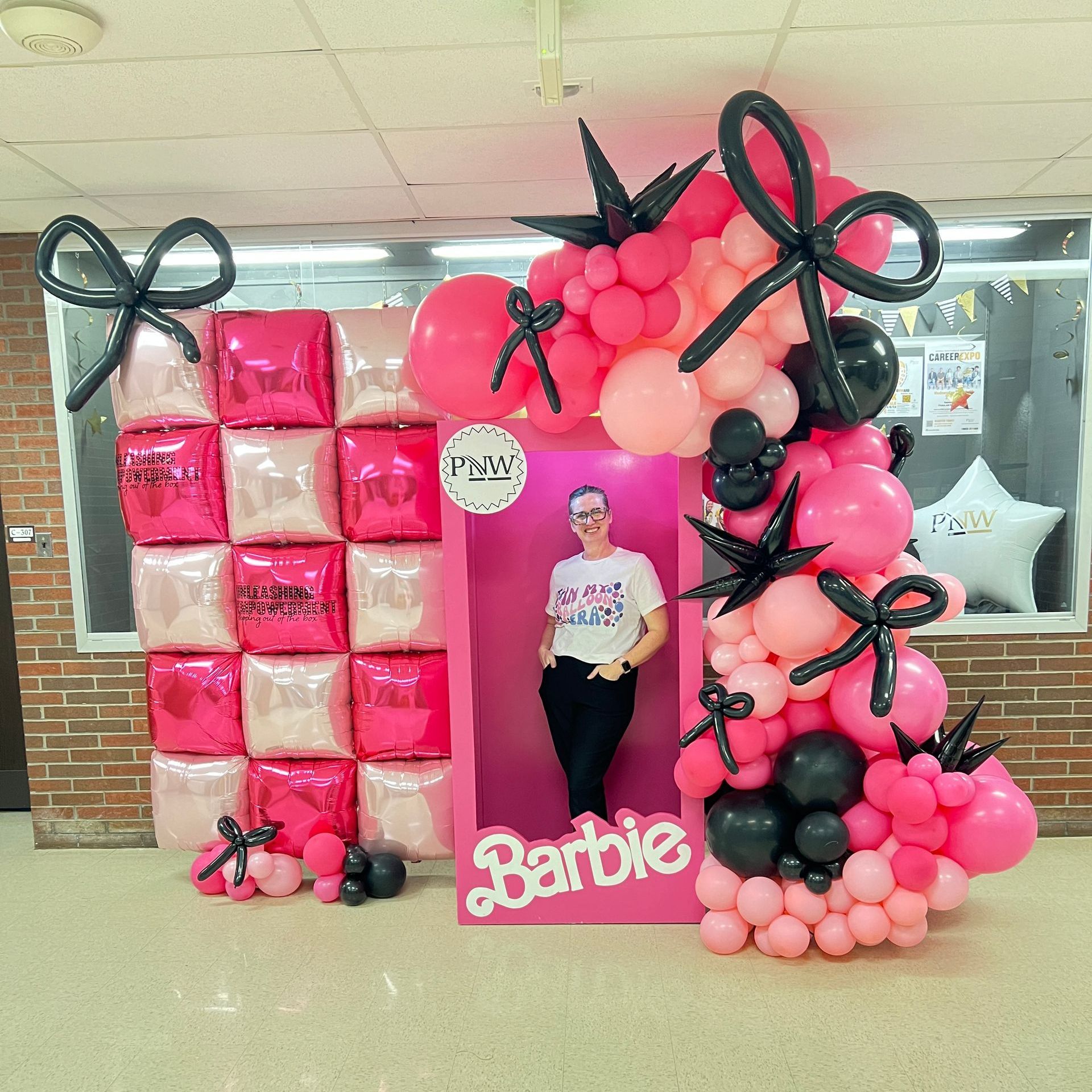 Women's empowerment event with a tuftex balloon wall, barbie box and styled balloon garland