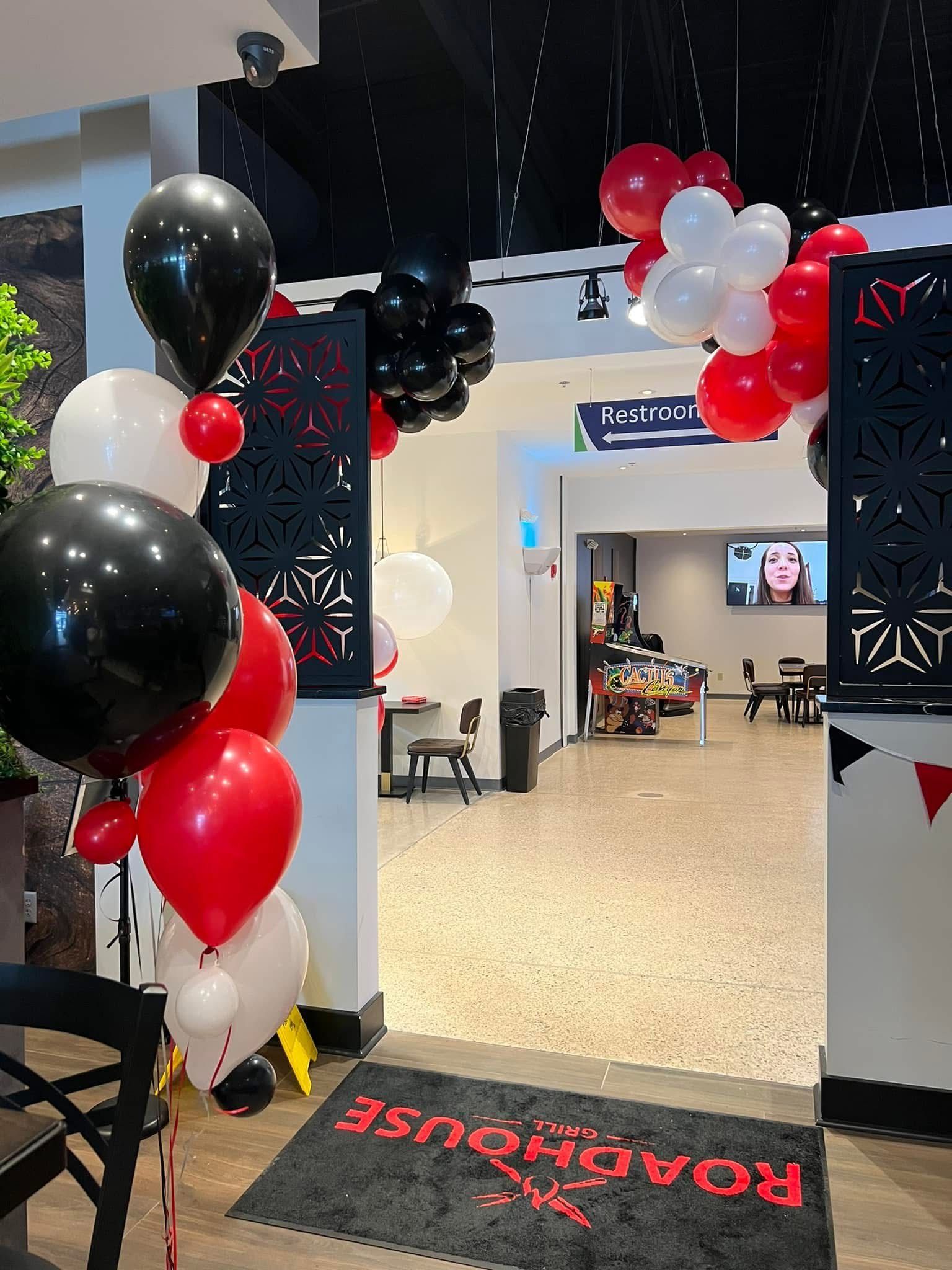 Black Light, Glow Balloon Arche with fun swirls at the entrance of a corporate event. 