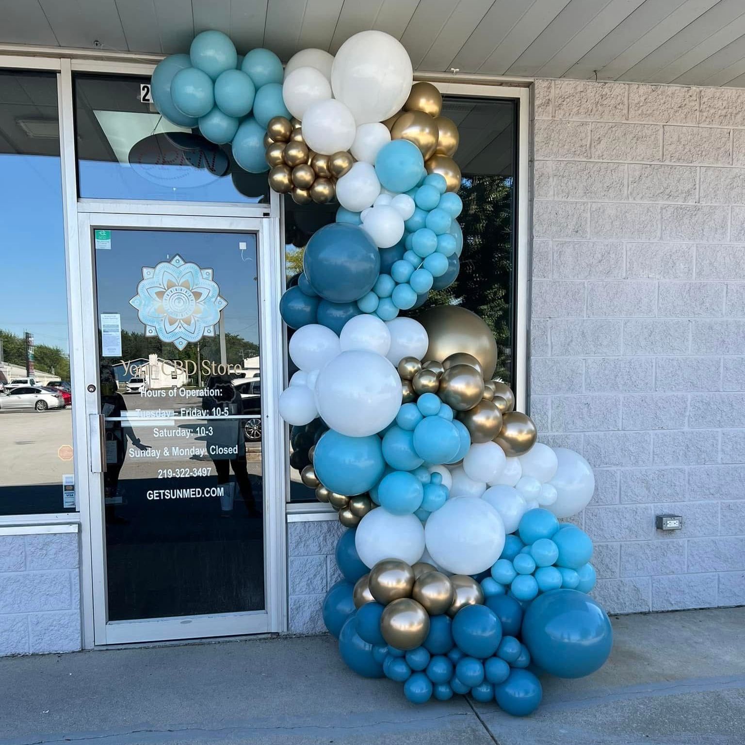 Your CBD Store grand opening in Schererville, Indiana, featuring our grand deluxe free-standing balloon garland in beautiful hues of blue, white, and chrome gold. Elegant and stunning decor that brings your vision to life and creates a memorable entrance for the celebration.