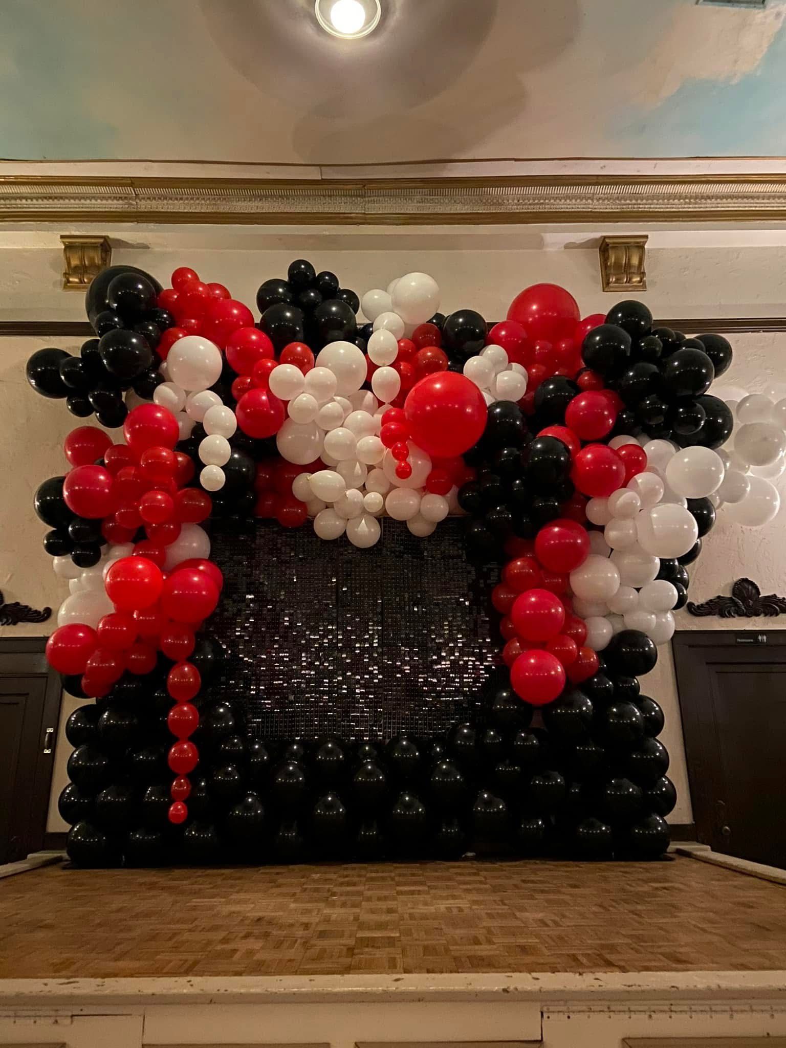 Black Light, Glow Balloon Arche with fun swirls at the entrance of a corporate event. 