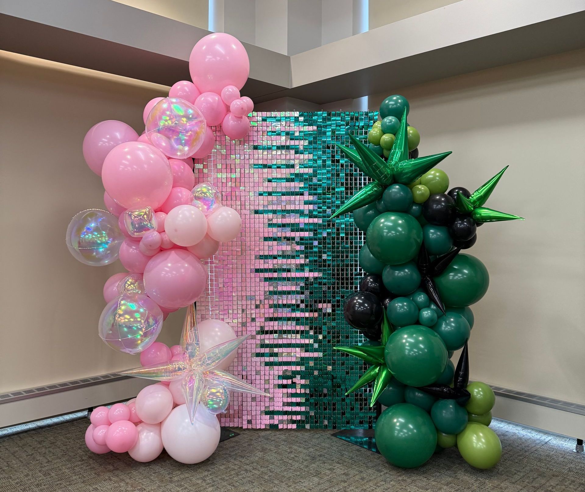 team glinda or team elphie? Wicked themed shimmer wall backdrop with balloon garlands