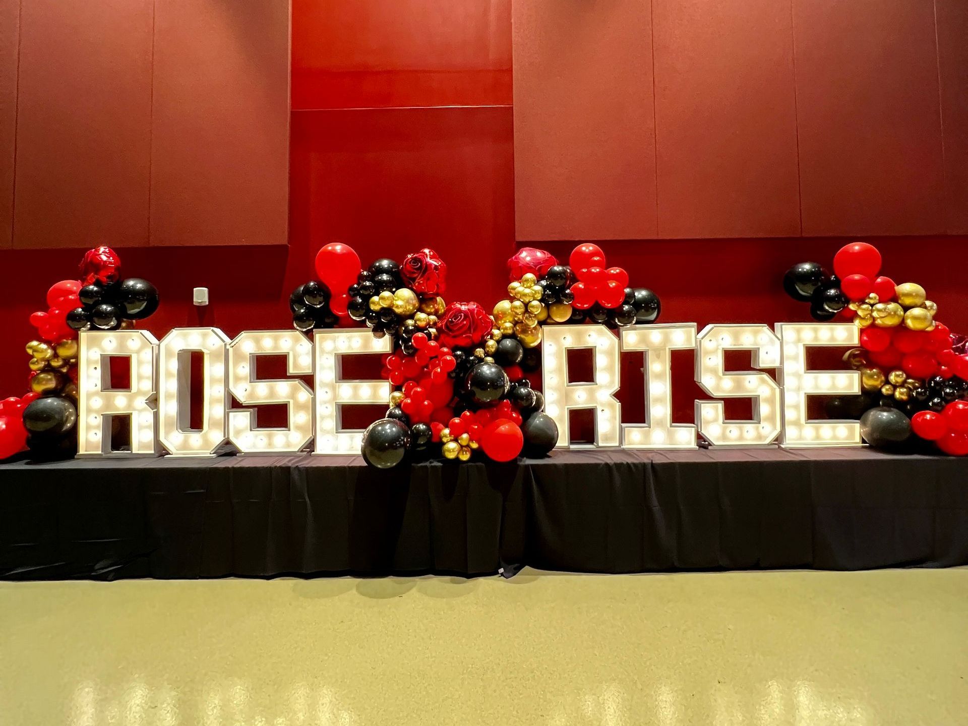 Rise and Rose LED marquee display with subtle balloon accents at a corporate event held at the Hard Rock Casino, perfect for brand activations and elegant event decor.