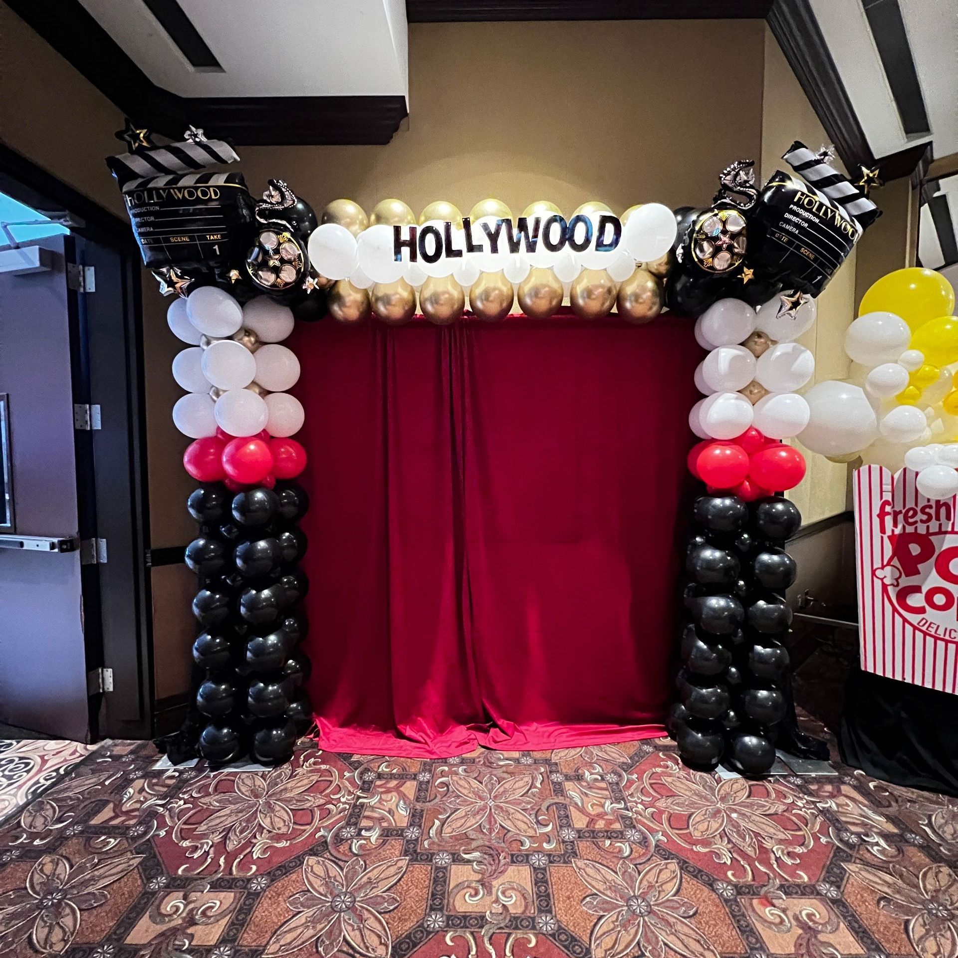 Themed hollywood square balloon arch for an annual meeting 