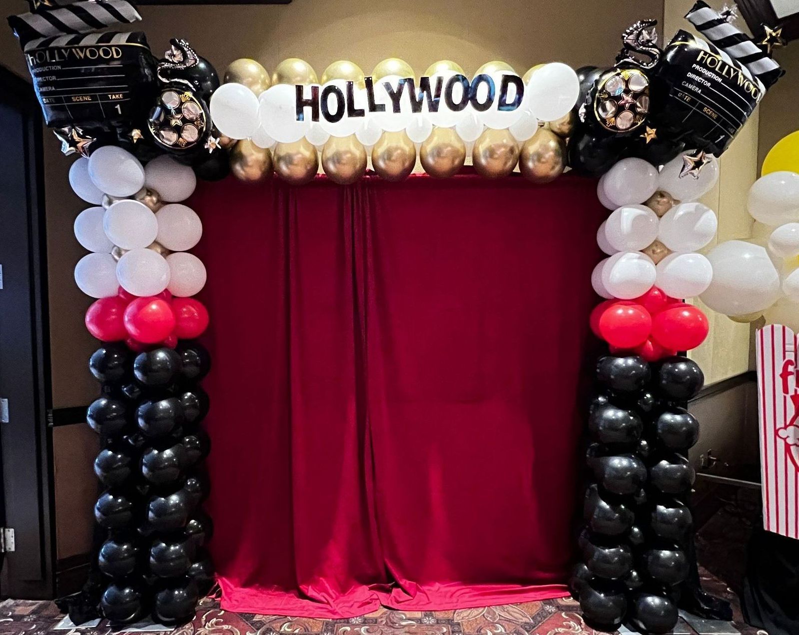 Cinema Theme Balloon Arch with red Velvet backdrop 