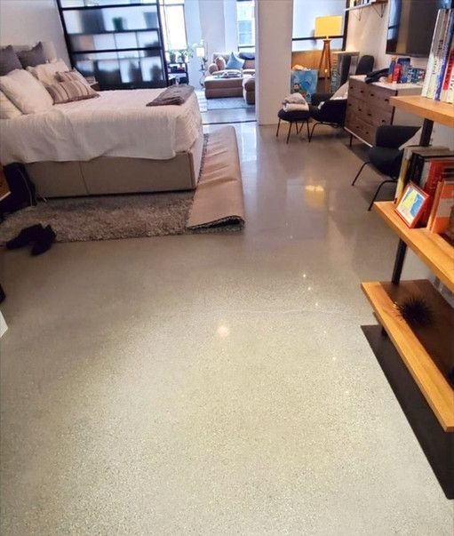 A bedroom with a bed and a rug on the floor