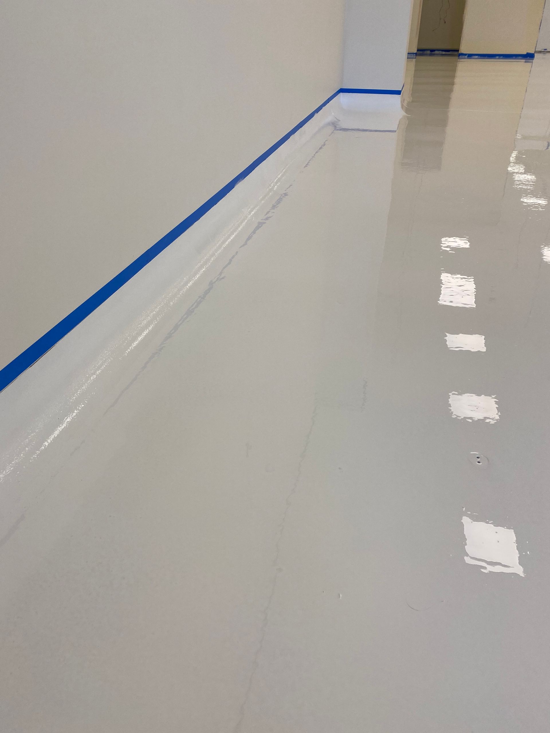 A white floor with a blue stripe on the corner.