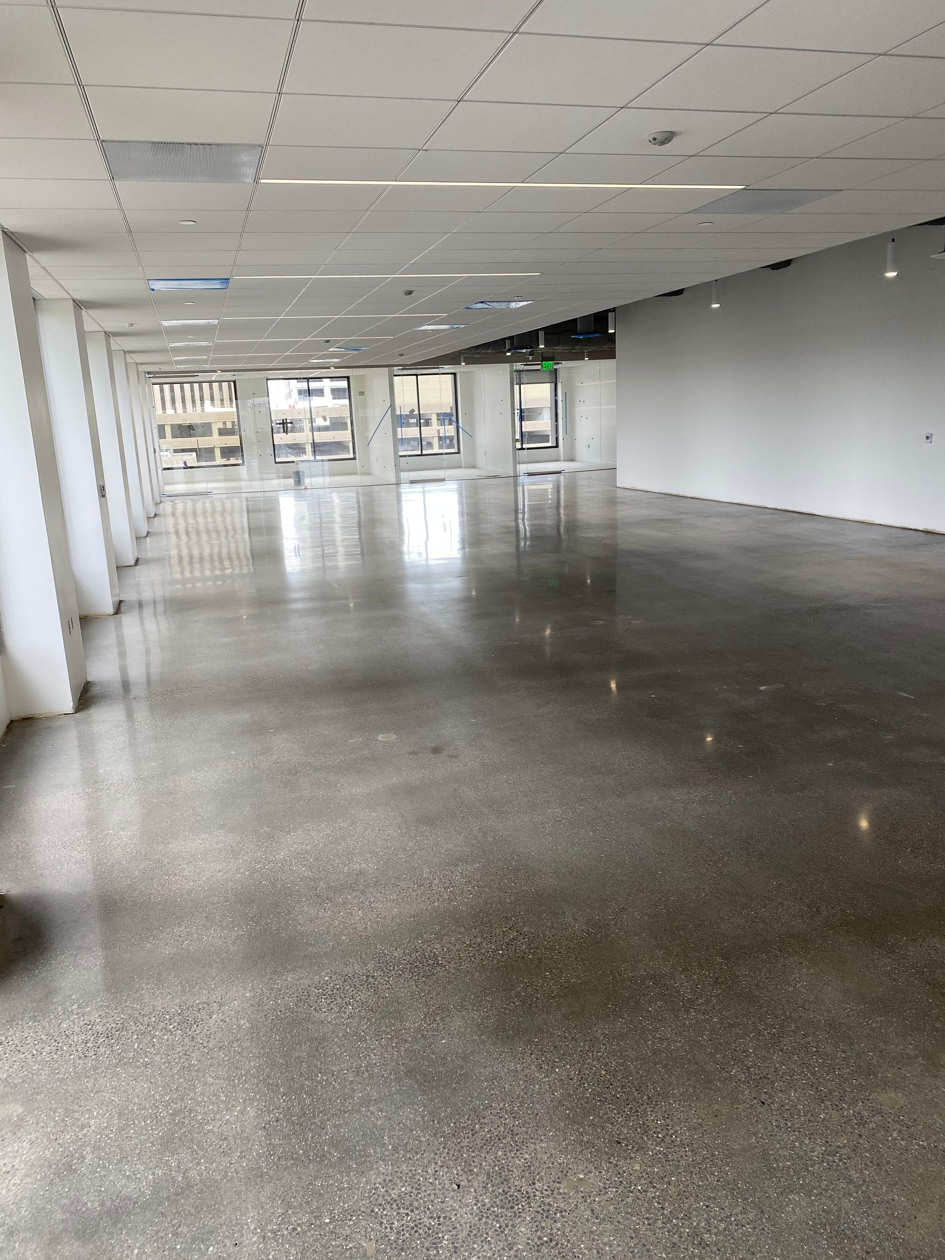 A large empty room with a shiny concrete floor