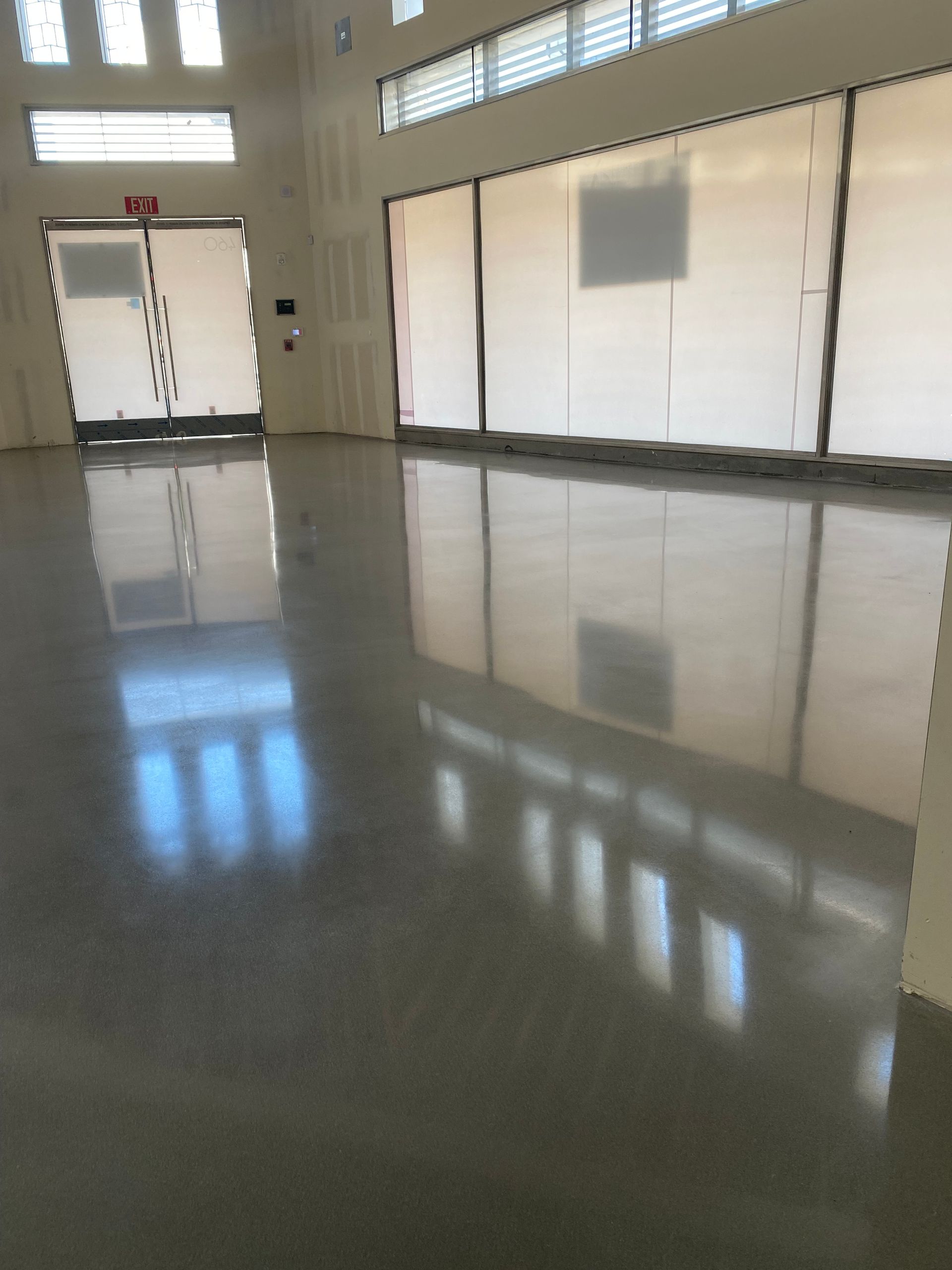 A large room with a reflection of a building in the floor