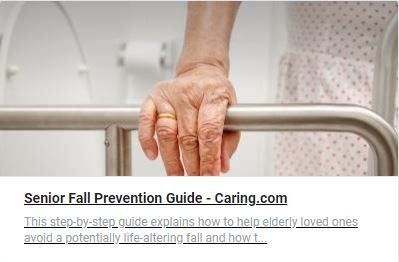 An elderly woman 's hand is holding onto a railing.