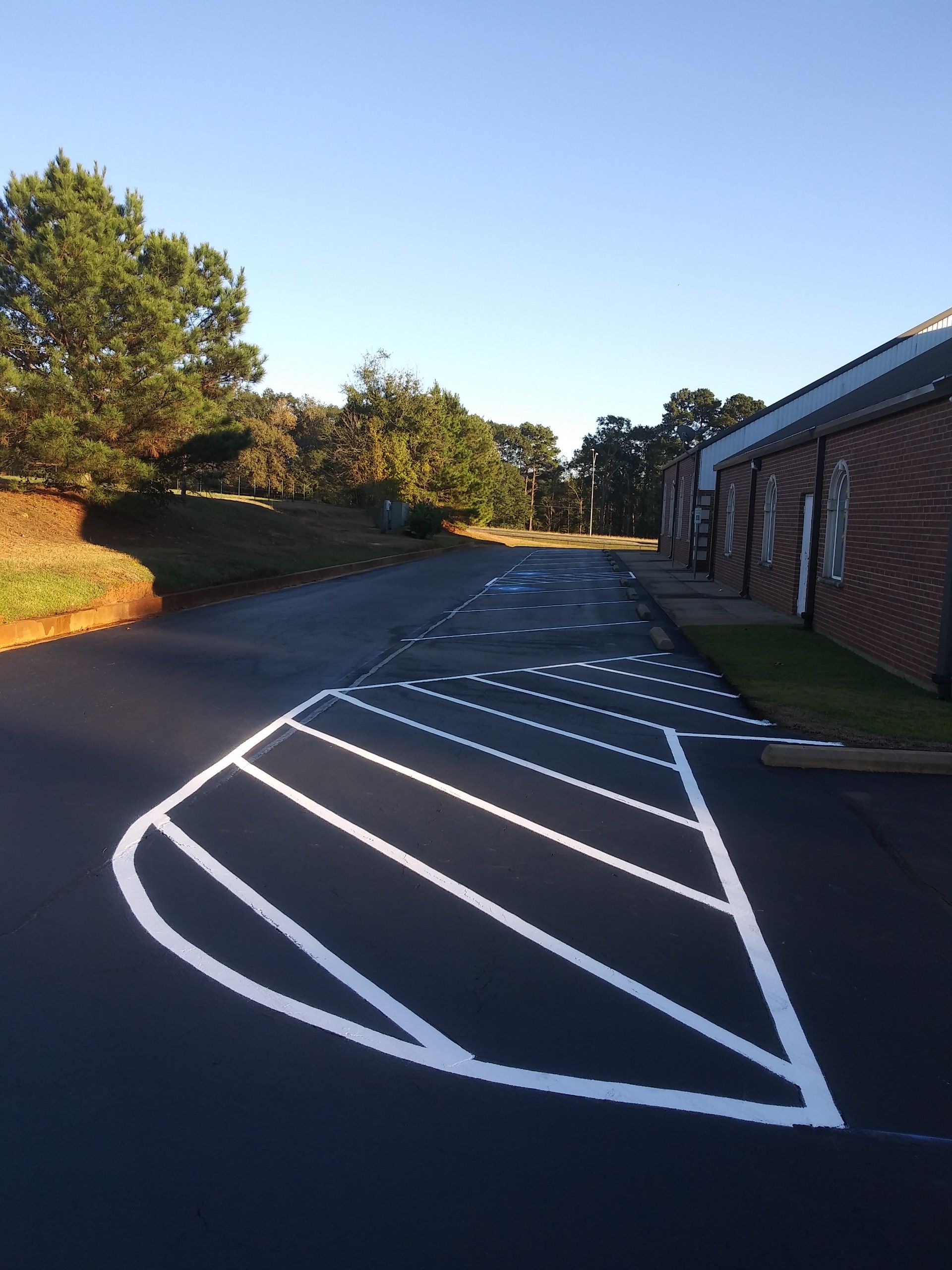 An Empty Parking Lot With Yellow Lines on It